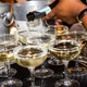 Bartender pouring Prosecco into glasses
